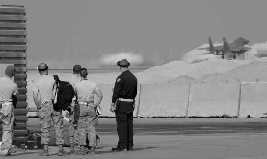 BAGRAM AIR BASE, Afghanistan - An F-15E takes off from the runway here as maintainers watch Dec. 7. (U.S. Air Force photo by Staff Sgt. Joshua T. Jasper)