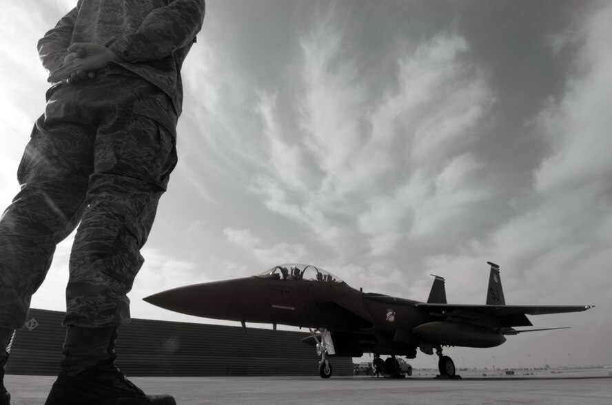 BAGRAM AIR BASE, Afghanistan - An F-15E crew chief stands ready to marshal his plane out for take off Dec. 7. (U.S. Air Force photo by Staff Sgt. Joshua T. Jasper)