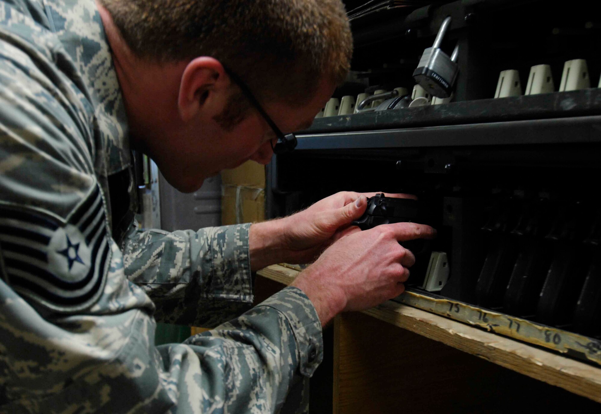 BAGRAM AIR BASE, Afghanistan - Aircrew life support technician Tech. Sgt. Ryan McMaster, 774th Expeditionary Airlift Squadron places an aircrew member's M-9 pistol into a secure gun rack, Dec. 12, 2007.  (U.S. Air Force photo/Staff Sgt. Joshua T Jasper)  (Released)
