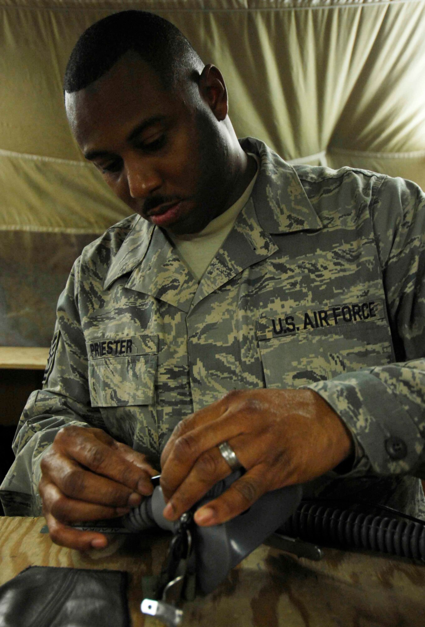 BAGRAM AIR BASE, Afghanistan - Aircrew life support technician Technical Sgt. Will Priester, 774th Expeditionary Airlift Squadron, performs a routine check on the equipment used by aircrew members here, Dec. 12, 2007.  (U.S. Air Force photo/Staff Sgt. Joshua T Jasper)  (Released)

