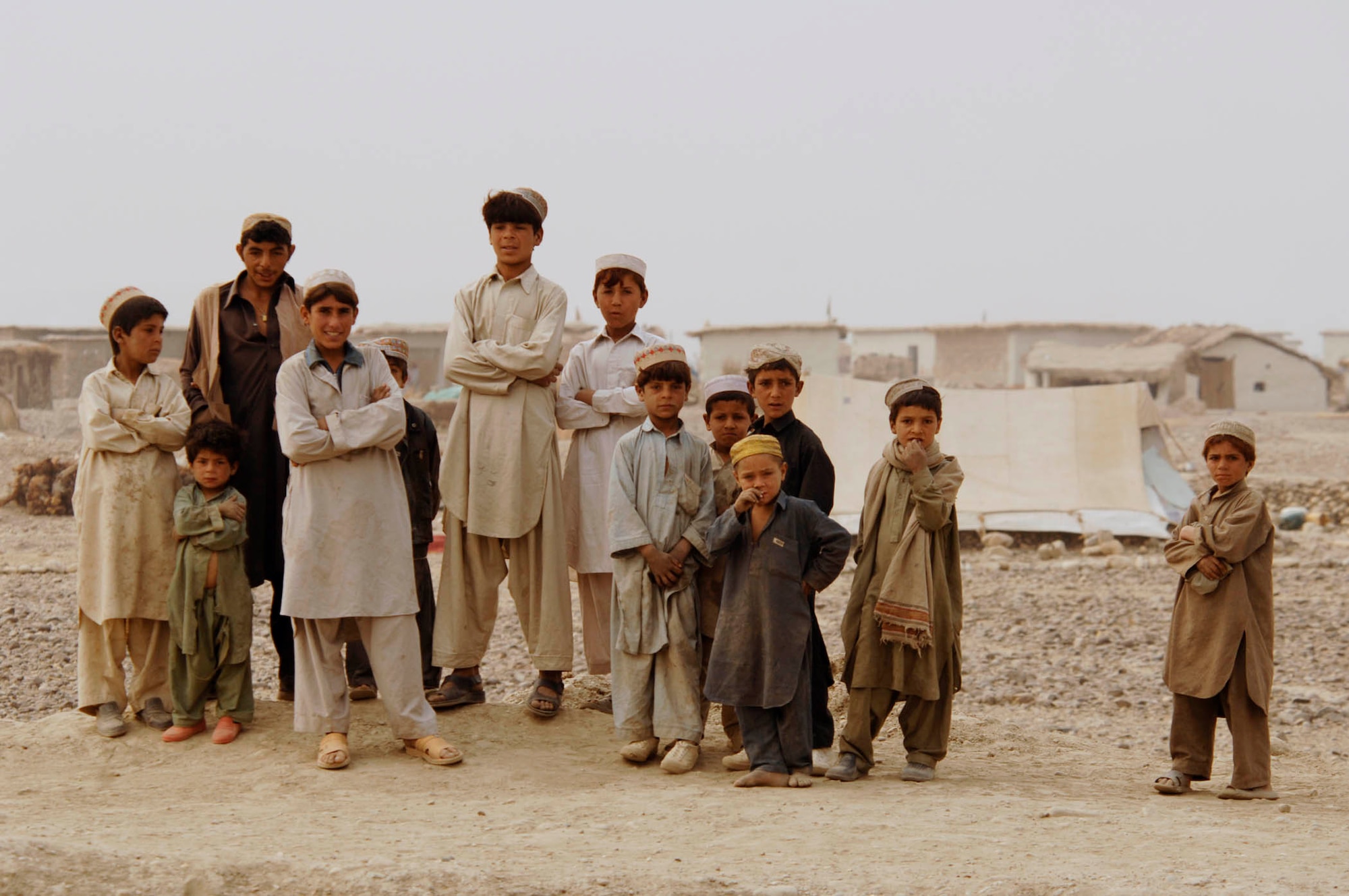 NANGARHAR PROVINCE, Afghanistan - A group of Afghan villagers watch the Nangarhar Provincial Reconstruction Team as they perform a canal assessment on Nov. 10, 2007.  The Nangarhar PRT is a joint team of Airman, Soldiers, and representatives from the U.S. Department of State, the U.S. Agency for International Development, and the U.S. Department of Agriculture.  The team is responsible for helping the Government of the Islamic Republic of Afghanistan improve security, governance and promote reconstruction in Nangarhar Province.  The PRT assesses community needs and then builds schools, government centers, roads, medical capability and basic infrastructure throughout the province; they also personally mentor Afghan government officials and security forces. (U.S. Air Force photo by Staff Sgt. Joshua T. Jasper)  (Released)