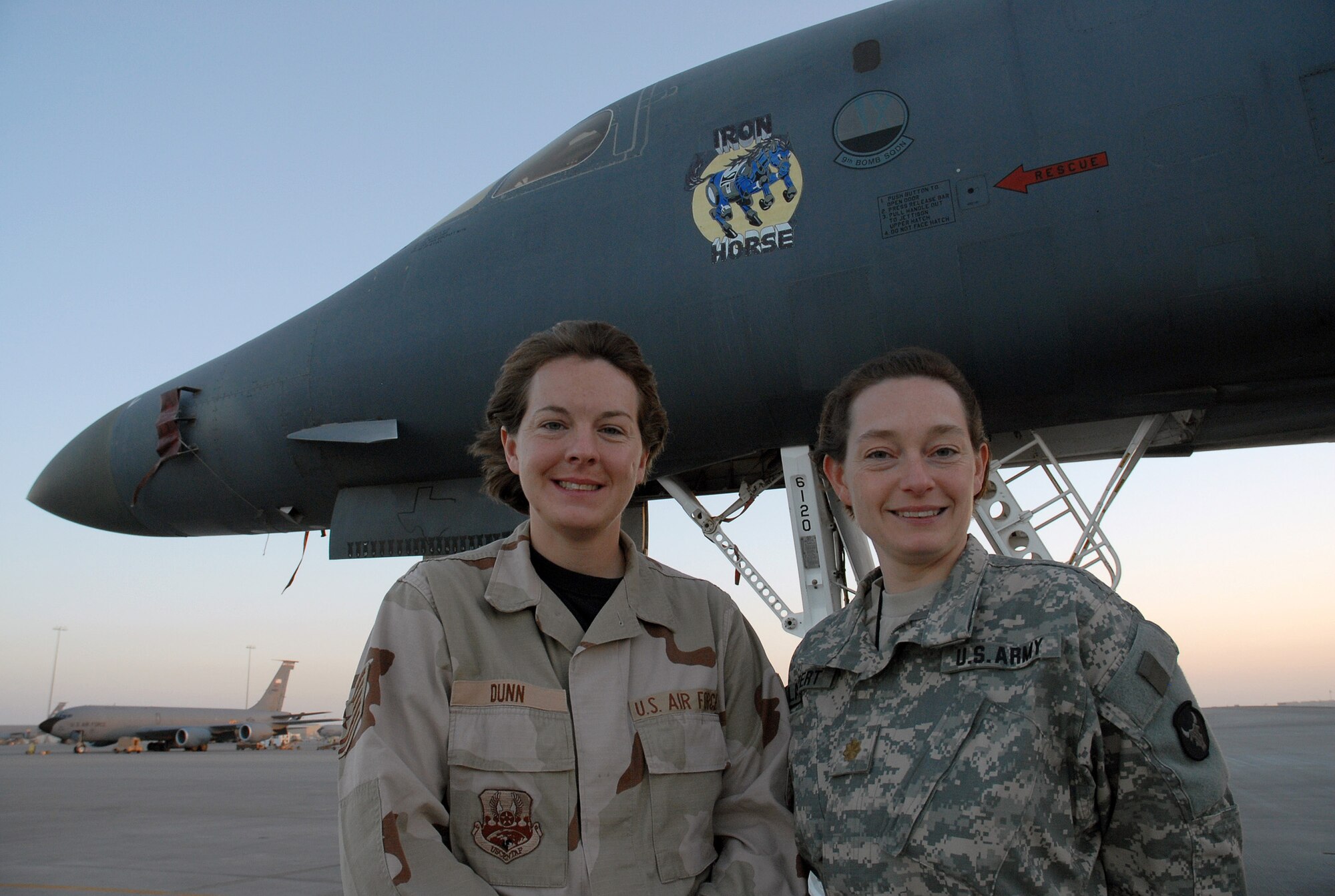 SOUTHWEST ASIA - Tech. Sgt. Jenny Dunn, 379th Expeditionary Squadron, weapons system technician, gives her sister, U.S. Army Maj. Melinda Lampert, a tour of a B-1B Lancer Bomber at a Southwest Asia air base Dec. 11. The sisters, both deployed to the Southwest Asia theater, met for a brief visit. Major Lampert is visiting her sister on a four-day pass from an Army Base in Iraq. Major Lampert is a physician's assistant with the Minnesota Army National Guard. Sergeant Dunn's home station is Ellsworth Air Force Base, S. D. The sister's hometown is Bowlus, Minn. (U. S. Air Force photo/Staff Sgt. Douglas Olsen)