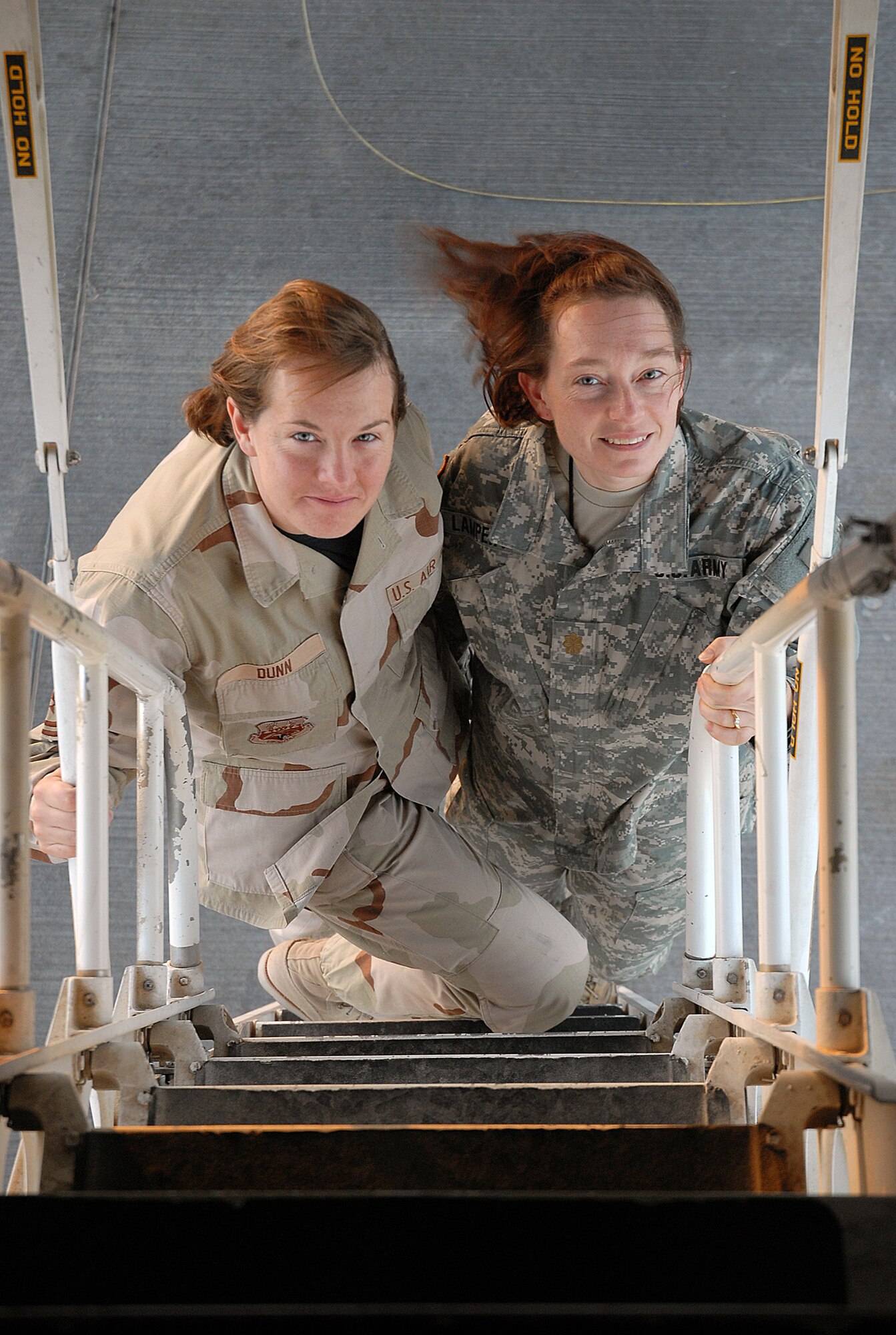 SOUTHWEST ASIA - Tech. Sgt. Jenny Dunn, 379th Expeditionary Maintenance Squadron weapons systems technician, gives her sister, U.S. Army Maj. Melinda Lampert, a tour of a B-1B Lancer Bomber at a Southwest Asia air base Dec. 11. The sisters, both deployed to the Southwest Asia theater, met for a brief visit. Major Lampert is visiting her sister on a four-day pass from an Army Base in Iraq. Major Lampert is a physician's assistant with the Minnesota Army National Guard. Sergeant Dunn's home station is Ellsworth Air Force Base, S. D. The sister's hometown is Bowlus, Minn. (U. S. Air Force photo/Staff Sgt. Douglas Olsen)