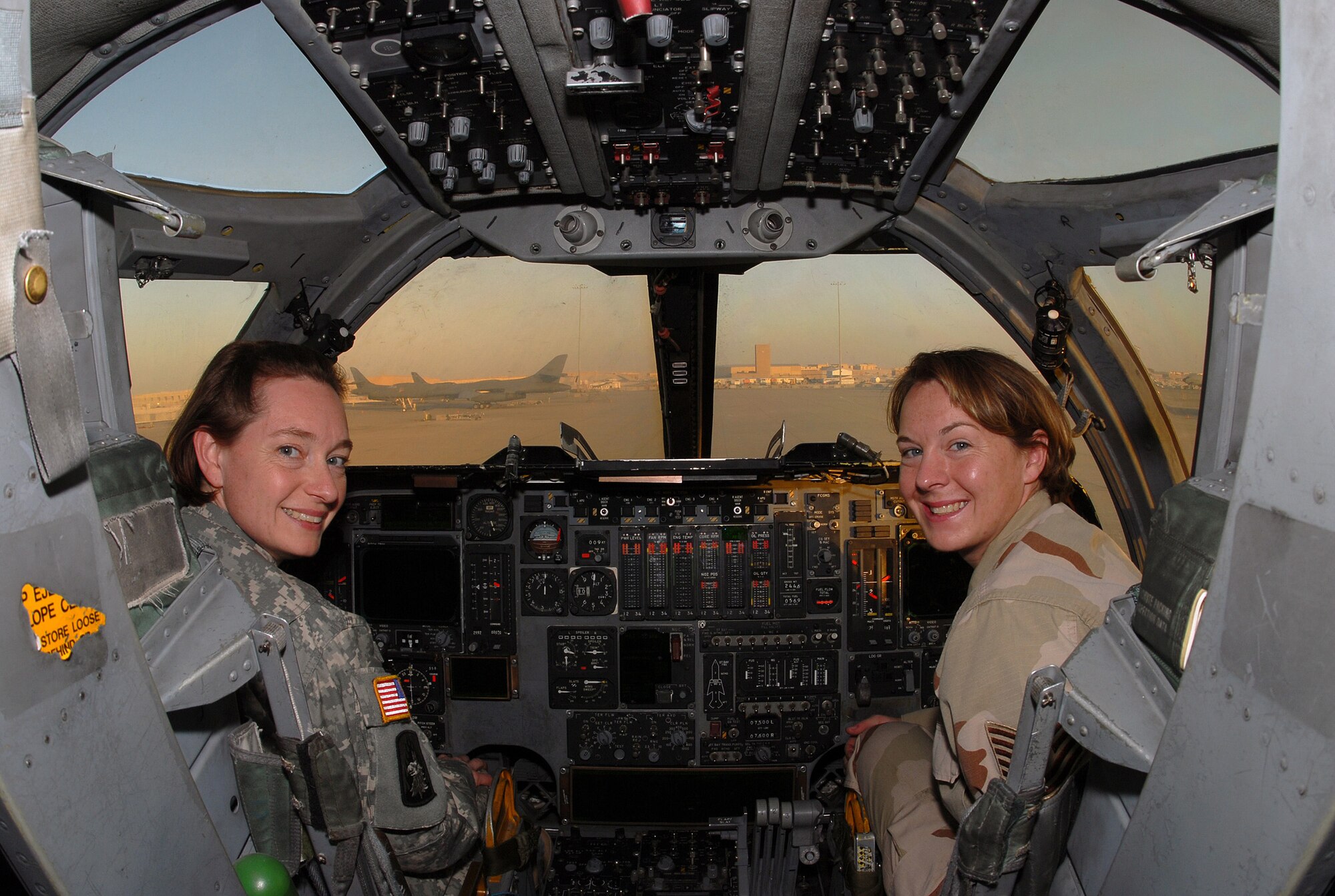 SOUTHWEST ASIA - Tech. Sgt. Jenny Dunn, 379th Expeditionary Maintenance Squadron, weapons system technician, gives her sister, U.S. Army Maj. Melinda Lampert, a tour of a B-1B Lancer Bomber at a Southwest Asia air base Dec. 11. The sisters, both deployed to the Southwest Asia theater, met for a brief visit. Major Lampert is visiting her sister on a four-day pass from an Army Base in Iraq. Major Lampert is a physician's assistant with the Minnesota Army National Guard. Sergeant Dunn's home station is Ellsworth Air Force Base, S. D. The sister's hometown is Bowlus, Minn. (U. S. Air Force photo/Staff Sgt. Douglas Olsen)