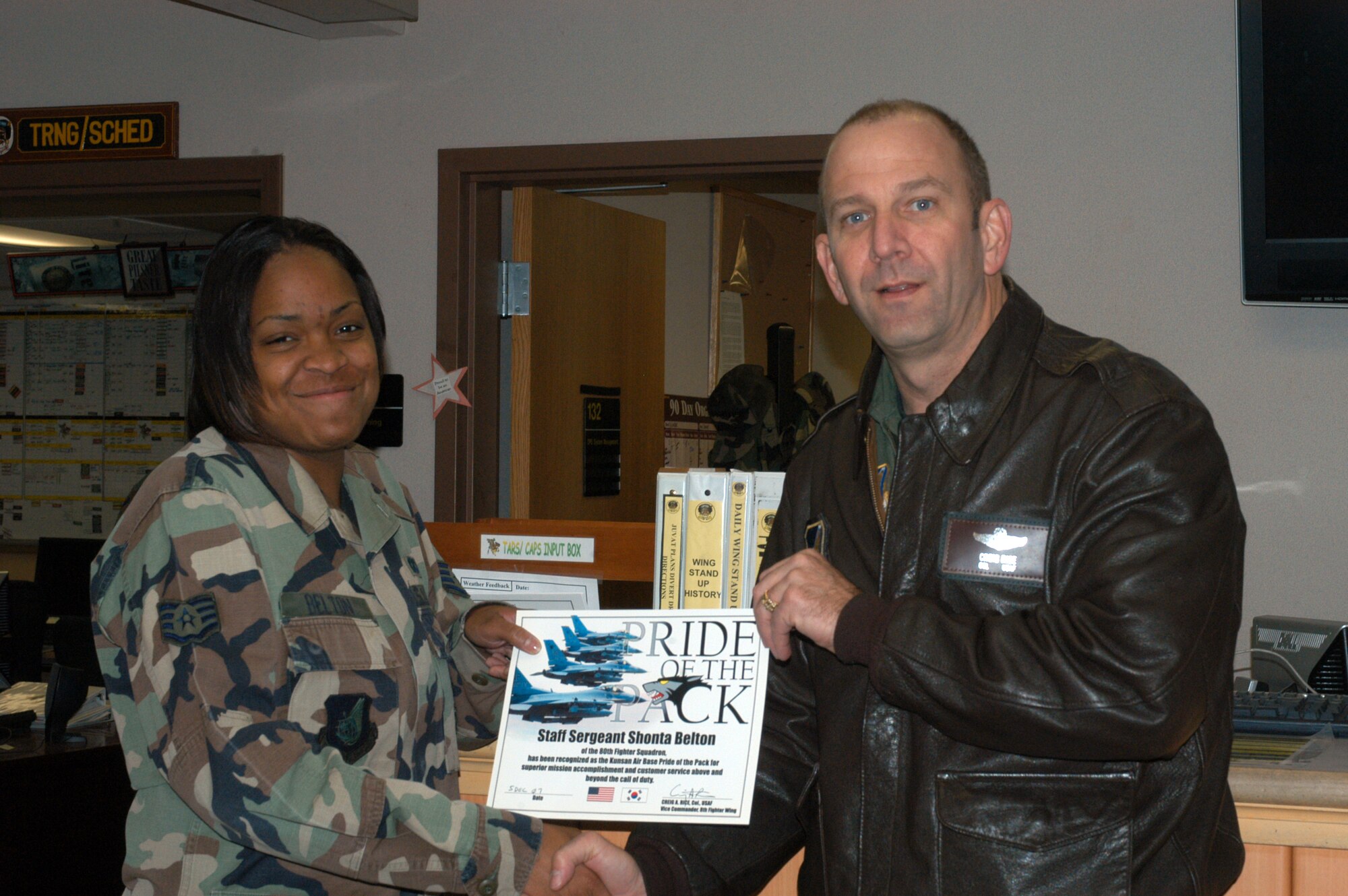 KUNSAN AIR BASE, South Korea --  Colonel Creig "Wolf 2" Rice, 8th Fighter Wing vice commander, congratulates Staff Sgt. Shonta Belton, 80th Fighter Squadron aviation resource manager here Dec. 5. Sergeant Belton was selected as the 8th Fighter Wing's Pride of the Pack for the week of Dec. 3. (U.S. Air Force photo/Staff Sgt. Alice Moore) 