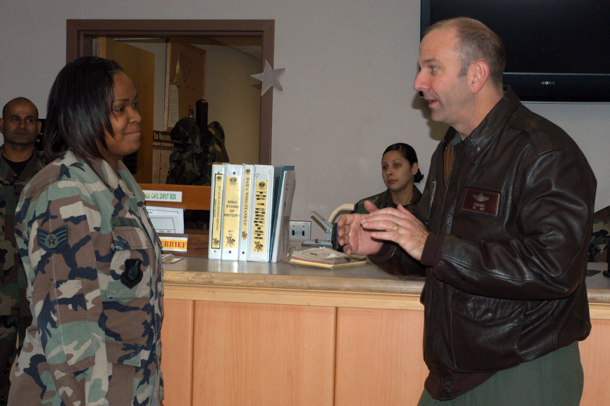 KUNSAN AIR BASE, South Korea --  Colonel Creig "Wolf 2" Rice, 8th Fighter Wing vice commander, congratulates Staff Sgt. Shonta Belton, 80th Fighter Squadron aviation resource manager here Dec. 5. Sergeant Belton was selected as the 8th Fighter Wing's Pride of the Pack for the week of Dec. 3. (U.S. Air Force photo/Staff Sgt. Alice Moore) 