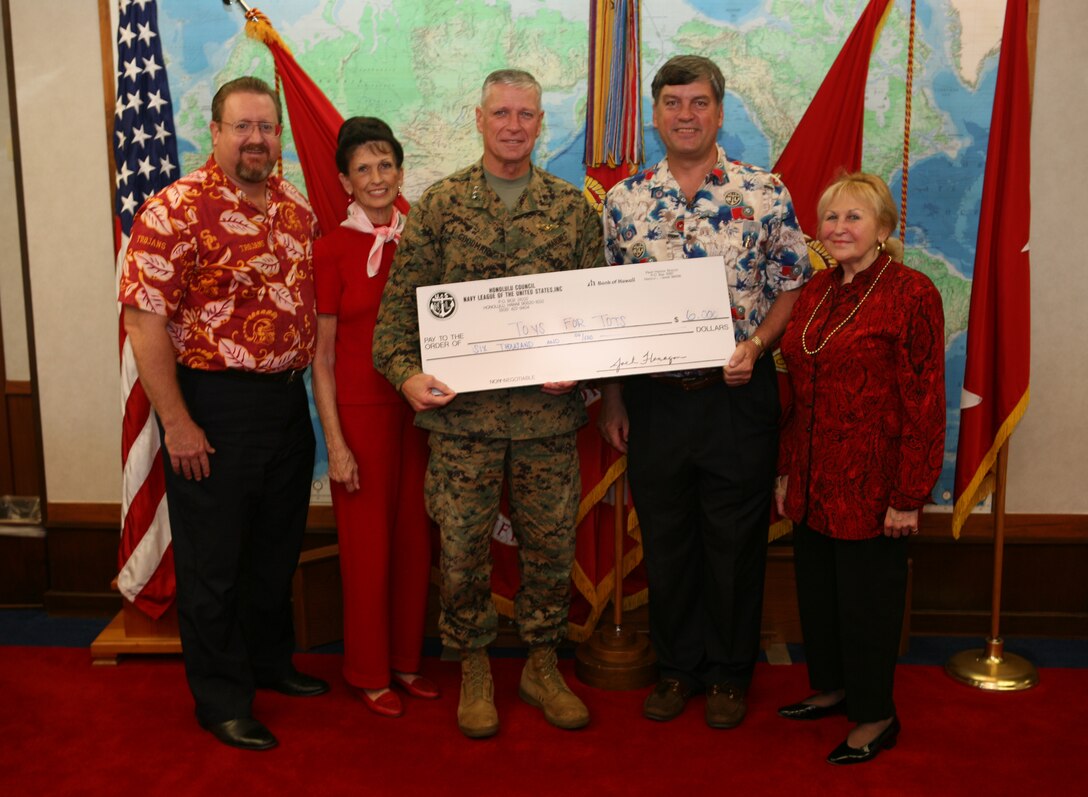 Honolulu Council Navy League staff came to present the a $6,000 check to Lt. Gen. John F. Goodman, commander, U.S. Marine Corps Forces Pacific on behalf of Toys for Tots, Dec. 14. From left to right: Bob McDermott, executive director, Carole Hickerson, golf committee lead, Lt. Gen. John F. Goodman, commander, U.S. Marine Corps Forces Pacific, Jack Flanagan, president, P. Pasha Baker, former president.