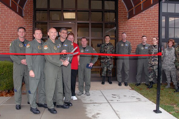 SCOTT AIR FORCE BASE, Ill. -- Colonel Curt Cannel, 375th Operations Group commander and staff cut the ribbon at Hangar One for the relocation of the 375th Operations Group Staff and the Operations Support Squadron including flight records. (U.S. Air Force photo by Marv Lynchard)