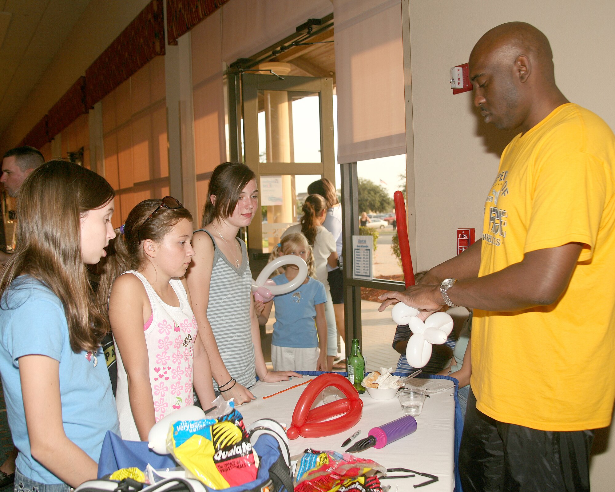 Tech. Sgt. Alan Jones makes hats and animals for a young audience at an event at Lackland Air Force Base, Texas. The base was recently named the eighth best place in the country to raise children. Sergeant Jones is with the  37th Logistics Readiness Squadron. (USAF photo by Robbin Cresswell)