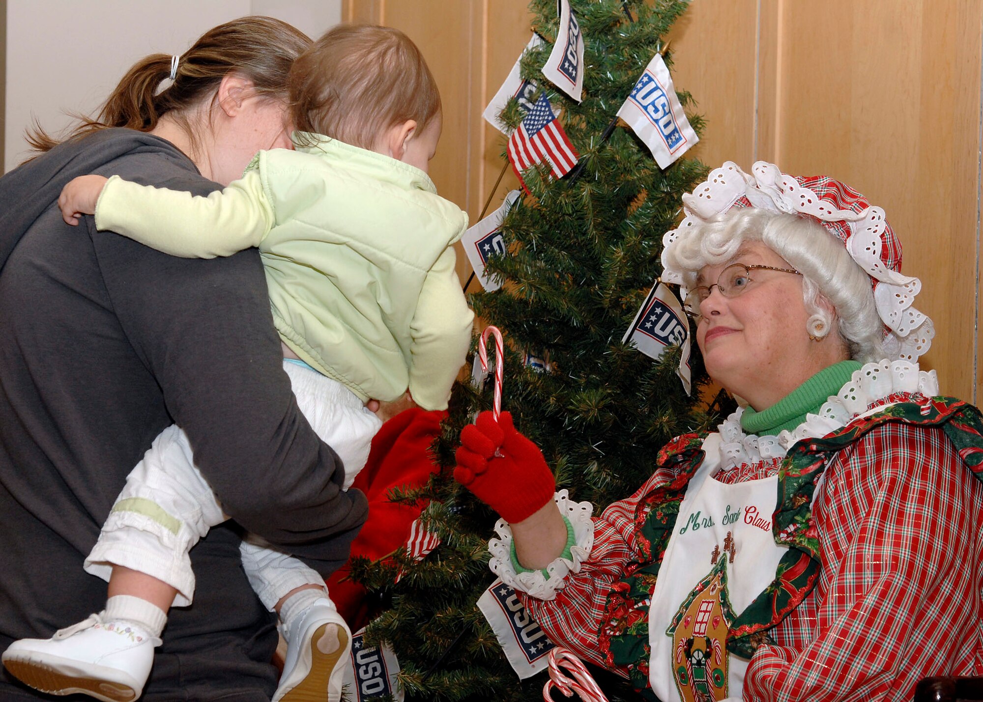 "Mrs. Claus" hands out candy canes to Joint Total Force Scott families during Santa Express at Union Station Dec. 8. (U.S. Air Force photo by Airman 1st Class Megan Gilliand)