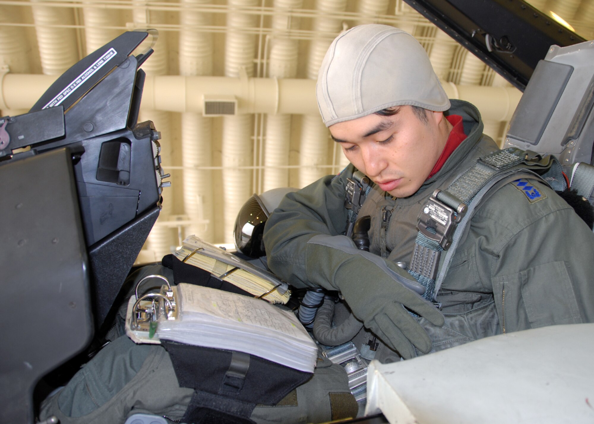 Capt. Jeong-Ho Cho (left), and Capt. Young-Kwon Ko (second from left) both KF-16C Fighting Falcon pilots assigned to the 157th Tactical Fighter Squadron, Seosan Air Base, Republic of Korea Air Force, conduct flight planning with Capt. William Bolton and Capt. Paul Davidson (right) both F-16C Fighting Falcon pilots assigned to the 36th Fighter Squadron, during the buddy wing program Dec. 11 to 13. The purpose of the buddy wing program is to exchange ideas, introduce tactics and improve interoperability between the U.S. and Republic of Korea air forces. (U. S. Air Force photo/Senior Master Sgt. Marvin Krause) 