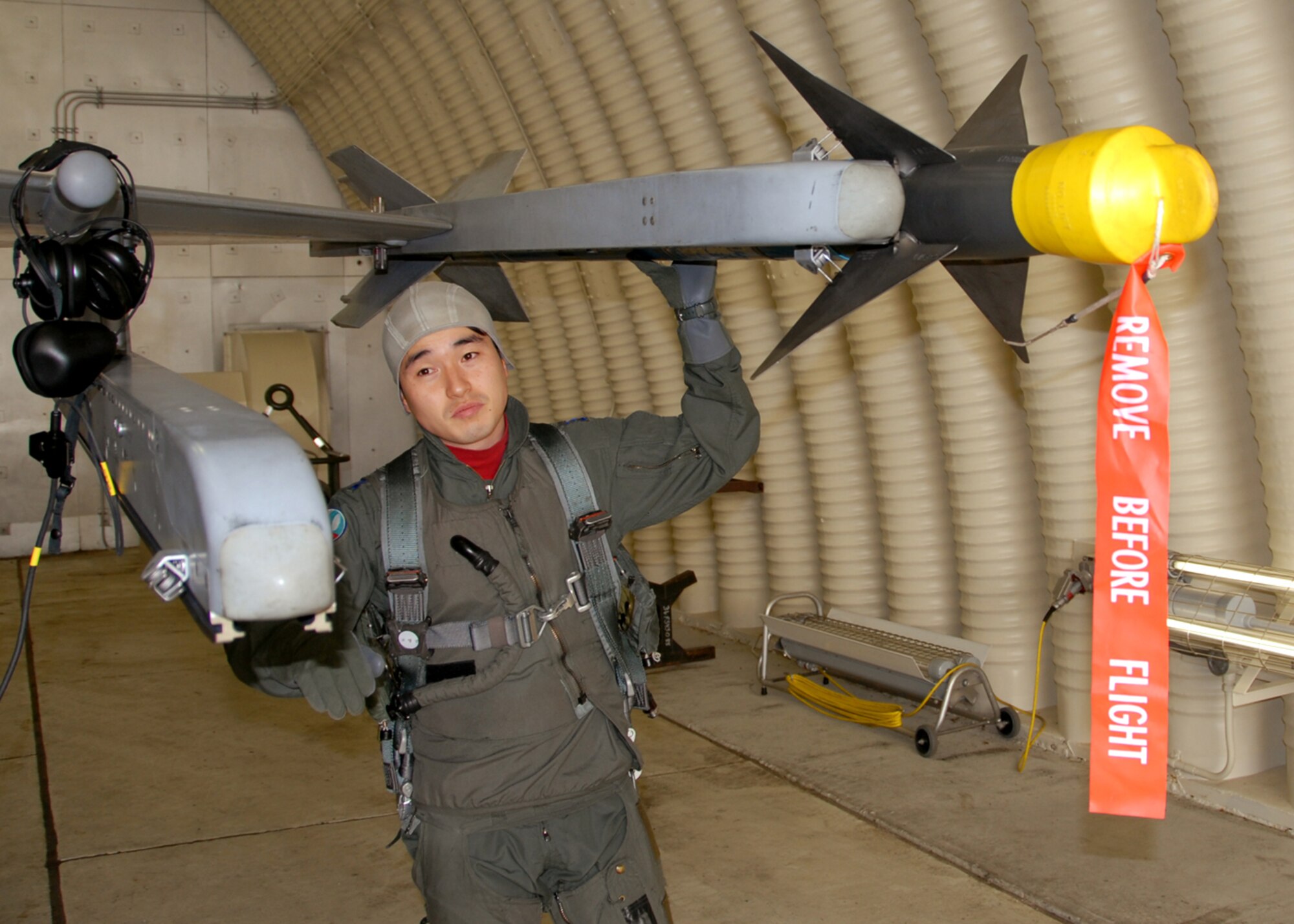 Capt. Young-Kwon Ko, a KF-16 Fighting Falcon pilot assigned to the 157th Tactical Fighter Squadron, Seosan Air Base, Republic of Korea air force, preflights his KF-16 aircraft prior to a buddy wing sortie with pilots from the 36th Fighter Squadron during the buddy wing program Dec. 11 to 13. The purpose of the buddy wing program is to exchange ideas, introduce tactics and improve interoperability between the U.S. and Republic of Korea Air Forces. (U. S. Air Force photo/Senior Master Sgt. Marvin Krause)