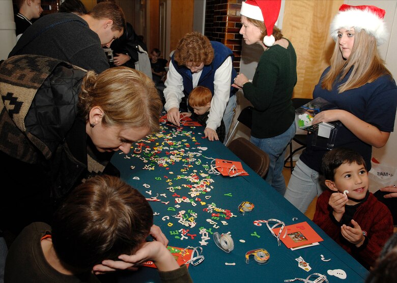 SCOTT AIR FORCE BASE, Ill. -- This holiday season Joint Total Force Scott started to celebrate in a variety of ways. Events kicked off with the USO and Jack Daniels Distillery “Toast to the Troops” concert on Dec. 4 featuring country music star Craig Morgan. Mr. Morgan along with more than a hundred Joint Total Force Scott members stuffed more than 10,000 USO care packages for deployed servicemembers. Joint Total Force Scott came out Thursday and braved the rain and snow to give out nearly 300 free holiday trees and to light the Scott tree. Saturday’s events started with the USO Santa Express event at Union Station in downtown St. Louis, which featured a free ride on the MetroLink and holiday activities for local military families, and ended with the 375th Airlift Wing Holiday party held at the Scott Club. The holiday season has just started for Joint Total Force Scott with many more events to come for more information on holiday events around Scott see upcoming issues of the Command Post. (U.S. Air Force photo by Airman 1st Class Megan Gilliand)