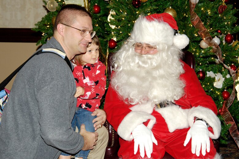 SCOTT AIR FORCE BASE, Ill. -- This holiday season Joint Total Force Scott started to celebrate in a variety of ways. Events kicked off with the USO and Jack Daniels Distillery “Toast to the Troops” concert on Dec. 4 featuring country music star Craig Morgan. Mr. Morgan along with more than a hundred Joint Total Force Scott members stuffed more than 10,000 USO care packages for deployed servicemembers. Joint Total Force Scott came out Thursday and braved the rain and snow to give out nearly 300 free holiday trees and to light the Scott tree. Saturday’s events started with the USO Santa Express event at Union Station in downtown St. Louis, which featured a free ride on the MetroLink and holiday activities for local military families, and ended with the 375th Airlift Wing Holiday party held at the Scott Club. The holiday season has just started for Joint Total Force Scott with many more events to come for more information on holiday events around Scott see upcoming issues of the Command Post. (U.S. Air Force photo by Marv Lynchard)