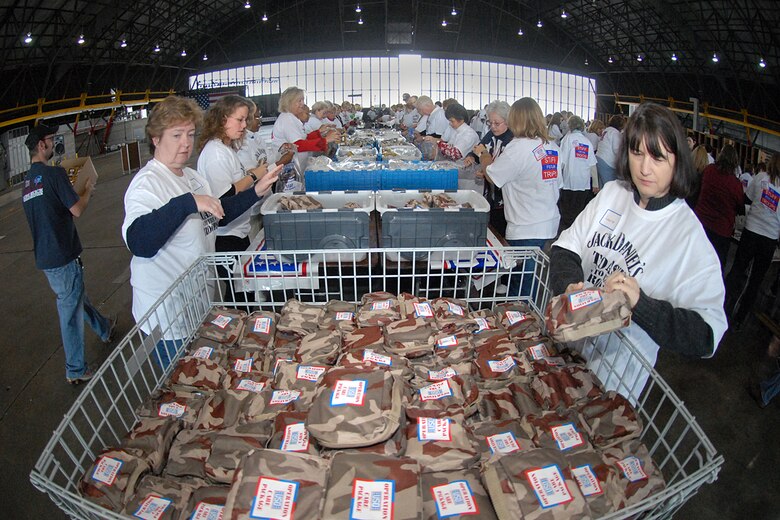 SCOTT AIR FORCE BASE, Ill. -- This holiday season Joint Total Force Scott started to celebrate in a variety of ways. Events kicked off with the USO and Jack Daniels Distillery “Toast to the Troops” concert on Dec. 4 featuring country music star Craig Morgan. Mr. Morgan along with more than a hundred Joint Total Force Scott members stuffed more than 10,000 USO care packages for deployed servicemembers. Joint Total Force Scott came out Thursday and braved the rain and snow to give out nearly 300 free holiday trees and to light the Scott tree. Saturday’s events started with the USO Santa Express event at Union Station in downtown St. Louis, which featured a free ride on the MetroLink and holiday activities for local military families, and ended with the 375th Airlift Wing Holiday party held at the Scott Club. The holiday season has just started for Joint Total Force Scott with many more events to come for more information on holiday events around Scott see upcoming issues of the Command Post. (U.S. Air Force photo by Marv Lynchard)