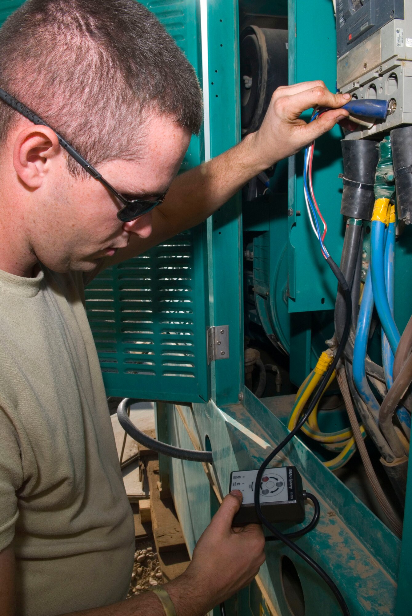 Senior Airman Paul Edwards checks the phase rotation on a generator's output Dec. 8 at Balad Air Base, Iraq. If the phase rotation is off, powered equipment will not function properly. Airman Edwards is a 332nd Expeditionary Civil Engineer Squadron power production maintainer and is deployed from the Missouri Air National Guard. (U.S. Air Force photo/Staff Sgt. Joshua Garcia)