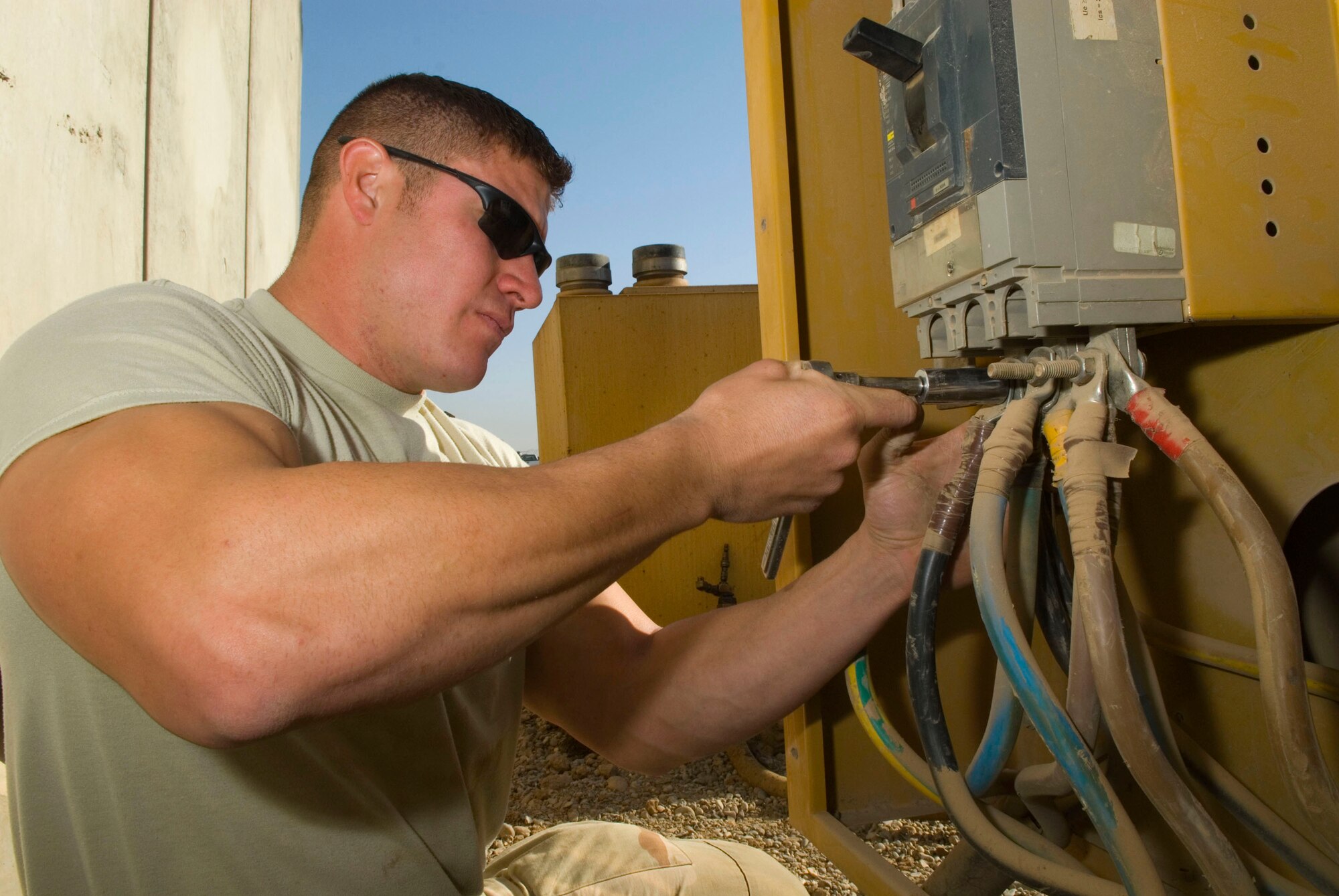 Senior Airman Charles Hernandez removes load distribution cables from a generator prior to being replaced Dec. 8 at Balad Air Base, Iraq. The cables output electricity to mission essential facilities on the base. Airman Hernandez is a 332nd Expeditionary Civil Engineer Squadron power production maintainer who is deployed from Kadena Air Base, Japan. (U.S. Air Force photo/Staff Sgt. Joshua Garcia) 