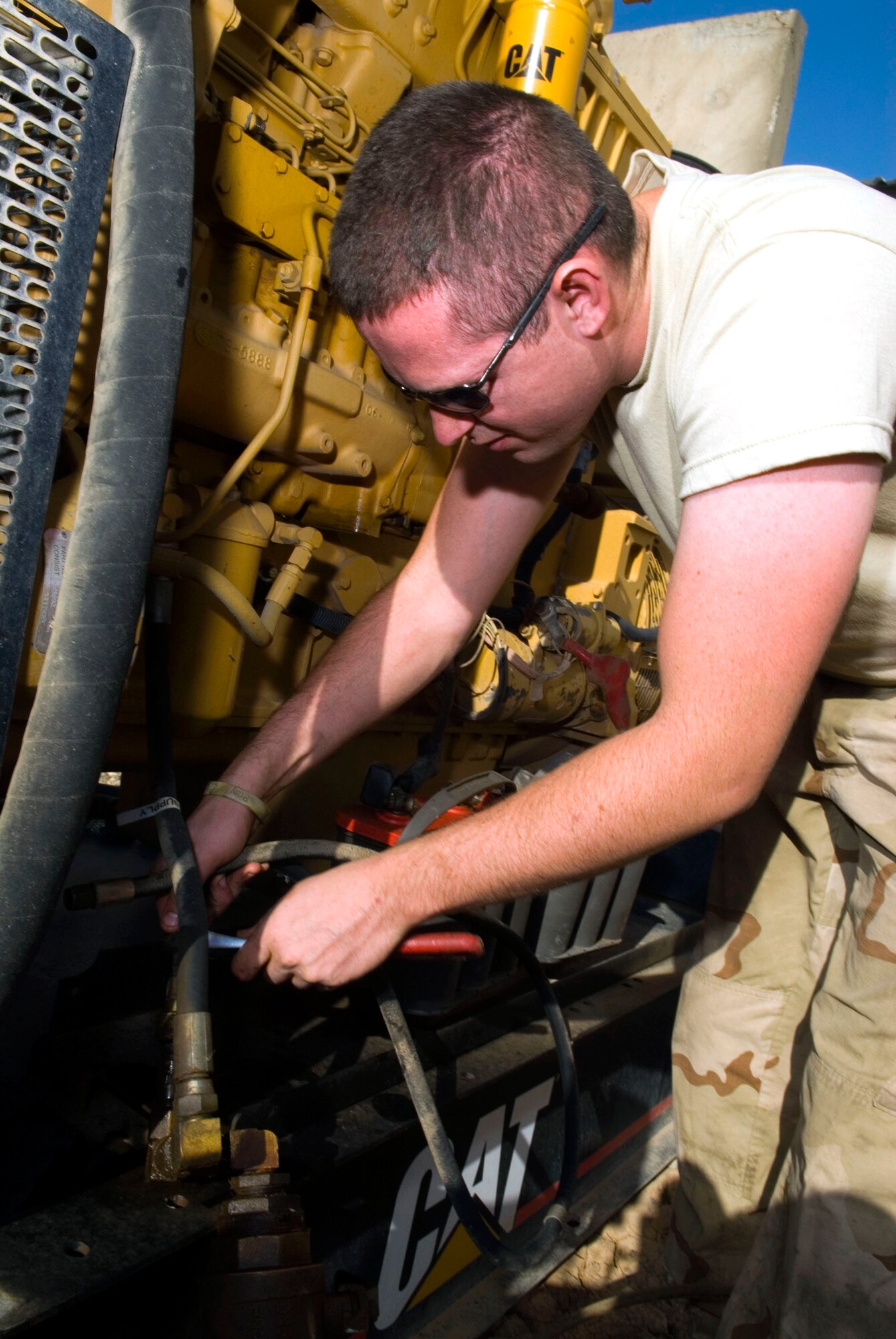 Senior Airman Paul Edwards disconnects a fuel line to a generator Dec. 8 at Balad Air Base, Iraq. Airman Edwards carefully ensures all connections are detached prior to the generator being moved and replaced. Airman Edwards is a 332nd Expeditionary Civil Engineer Squadron power production maintainer and is deployed from the Missouri Air National Guard. (U.S. Air Force photo/Staff Sgt. Joshua Garcia)