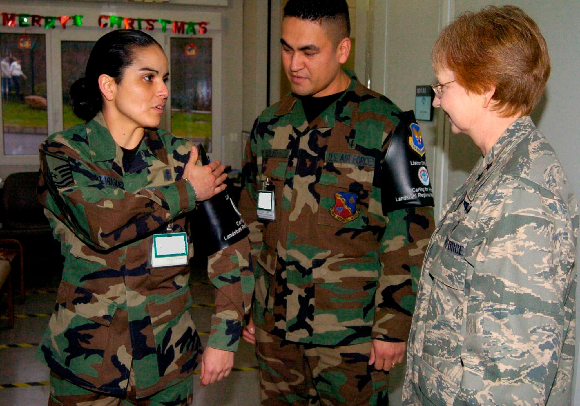 Master Sgt. Melissa Rodriguez displays her brassard to Maj. Gen. Melissa Rank Dec. 12 at Landstuhl Regional Medical Center, Germany. Sergeant Rodriguez and Tech. Sgt. Jose Solis wear the distinctive black arm bands to identify them as liaison officers who assist wounded servicemembers from operations Enduring Freedom and Iraqi Freedom with administrative patient needs during their stay at LRMC. General Rank is the assistant Air Force surgeon general for nursing services and medical force development. (U.S. Army photo/Chuck Roberts)