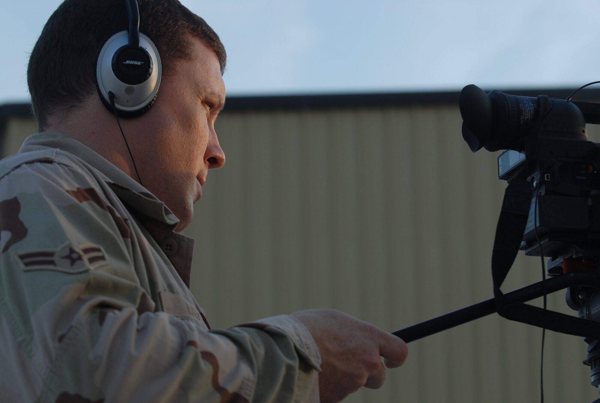 SOUTHWEST ASIA - Airman 1st Class William Knight, 379th Air Expeditionary Wing Public Affairs deployed from Whiteman Air Force Base, uses a video camera to document the latest events that occur in Southwest Asia. Airman Knight was recently recognized by Brig. Gen. Charlie Lyon, 379th AEW commander, for winning the Wing Staff Airman in the Month of Oct. (U.S. Air Force photo/Staff Sgt. Doug Olsen)