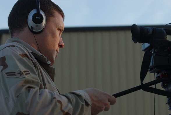 SOUTHWEST ASIA - Airman 1st Class William Knight, 379th Air Expeditionary Wing Public Affairs deployed from Whiteman Air Force Base, uses a video camera to document the latest events that occur in Southwest Asia. Airman Knight was recently recognized by Brig. Gen. Charlie Lyon, 379th AEW commander, for winning the Wing Staff Airman in the Month of Oct. (U.S. Air Force photo/Staff Sgt. Doug Olsen)