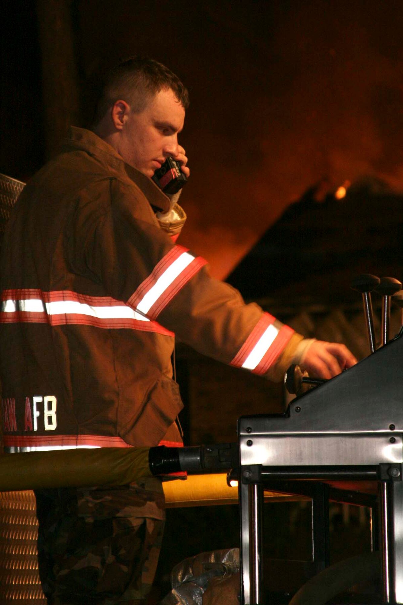 Sumter, S.C.-- Ariman 1st Class Adam Stephen, 20th Civil Engineer Squadron  firefighter, operates a pump panel at an off-base house-fire Dec. 11. Shaw operates in the local community under a memorandum of understanding
with Sumter County Fire Department.  If Sumter units are otherwise occupied
or unavailable, they contact the Shaw Fire Department to respond to the
incident. (U.S. Air Force photo/Airman 1st Class Michael Cowley)

