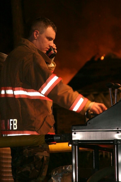 Sumter, S.C.-- Airman 1st Class Adam Stephen, 20th Civil Engineer Squadron  firefighter, operates a pump panel at an off-base house-fire Dec. 11. Shaw operates in the local community under a memorandum of understanding with Sumter County Fire Department. If Sumter units are otherwise occupied
or unavailable, they contact the Shaw Fire Department to respond to the incident. (U.S. Air Force photo/Airman 1st Class Michael Cowley)

