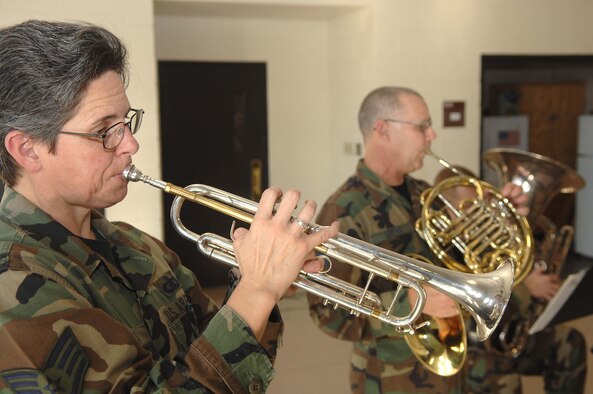 SHAW AIR FORCE BASE, S.C. -- Staff Sgt. Cheryl Przytula plays the trumpet and Master Sgt. Dave Crites plays the french horn while performing for the 20th Civiil Engineer Squadron Fire Department for a Christmas morale booster Dec. 12. Sergeants Przytula and Crites are part of the Heritage Brass Quintet, which is part of the U.S. Air Force Heritage of America Band from Langley Air Force Base, Va. The Quintet performed at 10 different locations before departing Shaw. (U.S. Air Force photo/Staff Sgt. Nathan Bevier)