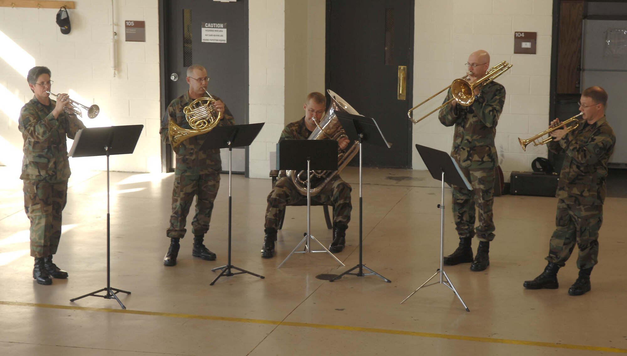 SHAW AIR FORCE BASE, S.C. -- The Heritage Brass Quintet, part of the U.S. Air Force Heritage of America Band from Langley Air Force Base, Va., performs for the 20th Civiil Engineer Squadron Fire Department for a Christmas morale booster Dec. 12. The members are from left to right: Staff Sgt. Cheryl Przytula on the trumpet, Master Sgt. Dave Crites on the french horn, Staff Sgt. Chris Moore on the tuba, Staff Sgt. Jason Foster on the trombone and Staff Sgt. Mark Nixon on the trumpet. The Quintet performed at 10 different locations before departing Shaw. (U.S. Air Force photo/Staff Sgt. Nathan Bevier)
