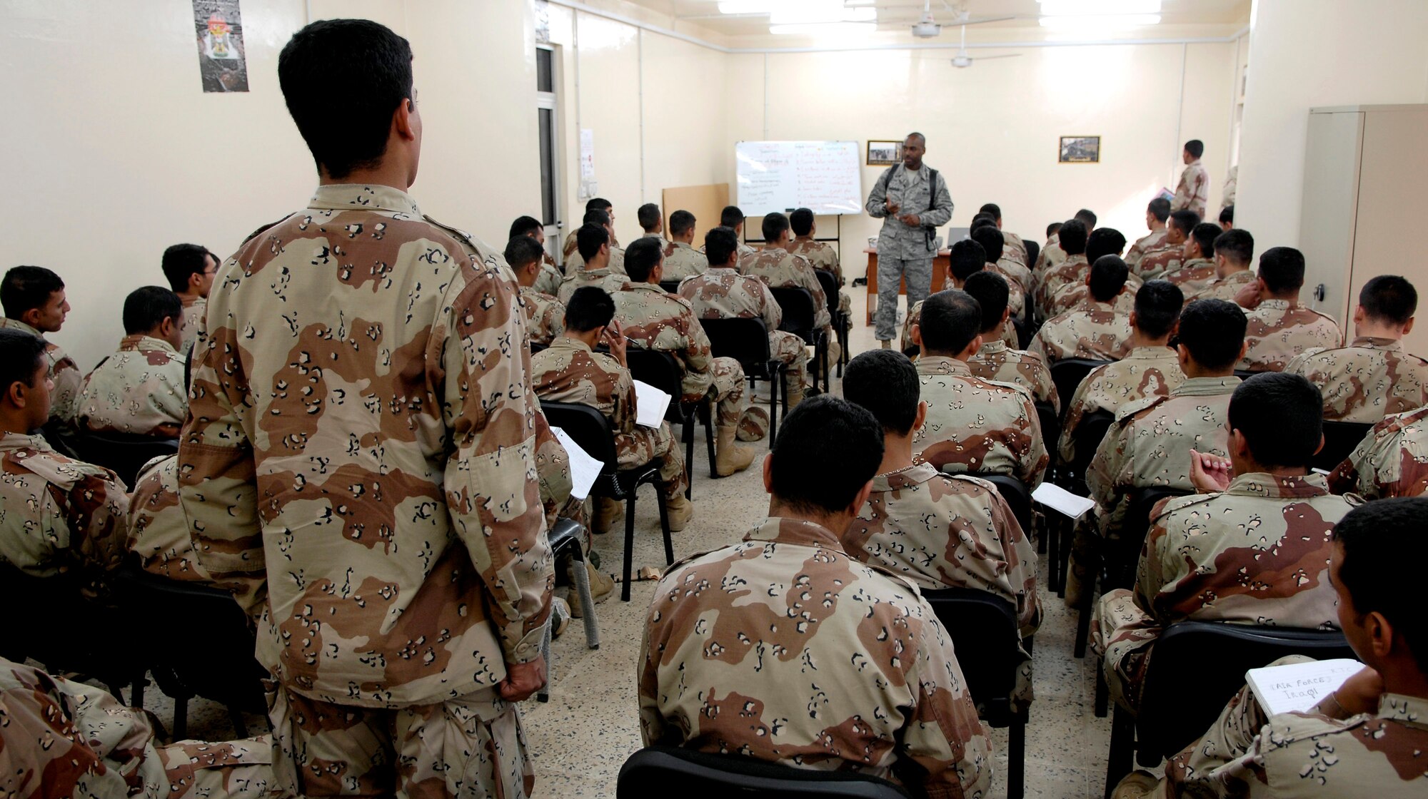 Tech. Sgt. Lamar Anderson teaches a class on core values to a group of Iraqi air force warrant officer trainees. Sergeant Anderson is a military training instructor from Lackland Air Force Base, Texas, and is assigned to the 370th Expeditionary Training Squadron, at Taji Air Base, Iraq. The Lackland AFB MTIs are helping to mold Iraq's future leaders. (U.S. Air Force photo/Staff Sgt. Brian Ferguson)