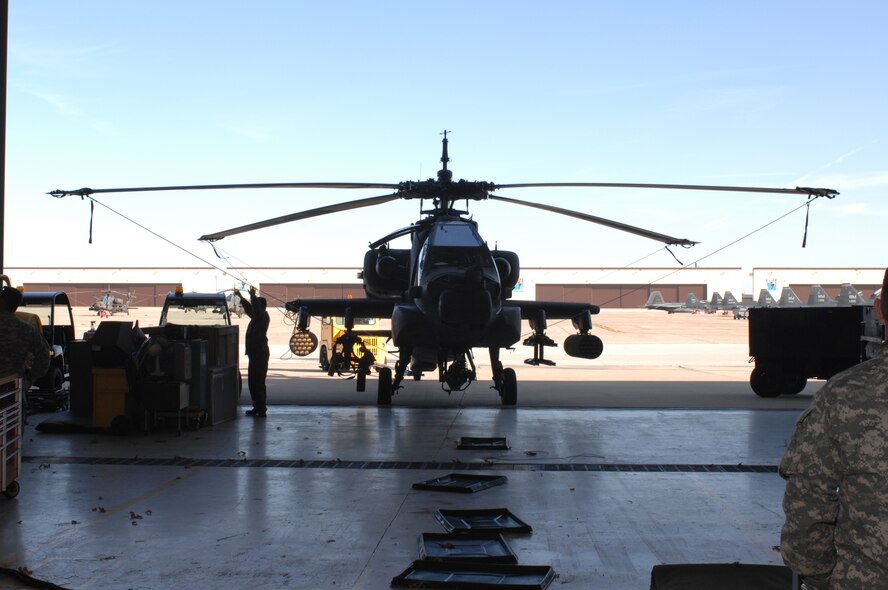 WHITEMAN AIR FORCE BASE, Mo. – Members of the 1-135th Attack Reconnaissance Battalion towing an AH-64 Apache Helicopter into the hanger for maintaince Nov. 05. (U.S. Air Force photo/Tech. Sgt. Samuel A. Park)