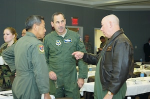 General T. Michael Moseley, Chief of Staff of the Air Force, speaks with Maj. Gen. Darryl Wong, Hawaii Air National Guard commander, and Lt. Gen. Ray Johns, Deputy Chief of Staff for Air Force Strategic plans and Programs, while on a break during a conference at the Air National Guard Readiness Center here, Dec. 5. (US Air Force/A1C Renae Kleckner)