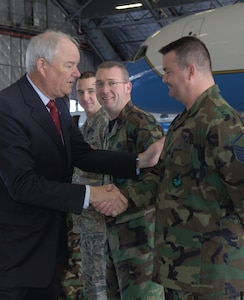 Hon. Michael W. Wynne, Secretary of the Air Force, shakes hands with Master Sgt. Bernard Smith, 89th Maintenance Group, during his visit to Andrews Dec. 4. The Secretary of the Air Force spent the day touring the 89th Airlift Wing as part of an official visit. (US Air Force/A1C Renae Kleckner)