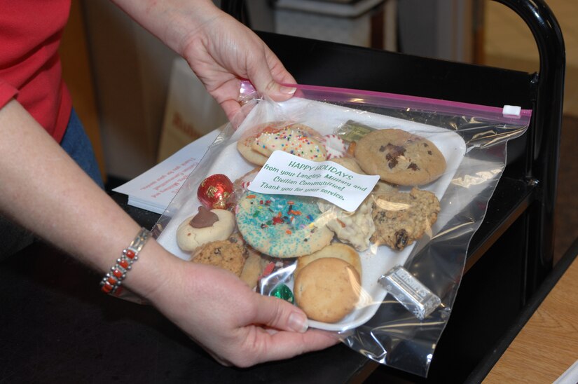 LANGLEY AIR FORCE BASE, Va. -- The Langley Officers' Spouses Club prepares cookie packages during their annual Airmen’s Cookie Drive Dec. 14. More than 2,000 dozen cookies were distributed to dormitory residence and other base personnel. (U.S. Air Force photo/Staff Sgt. April Wickes) 