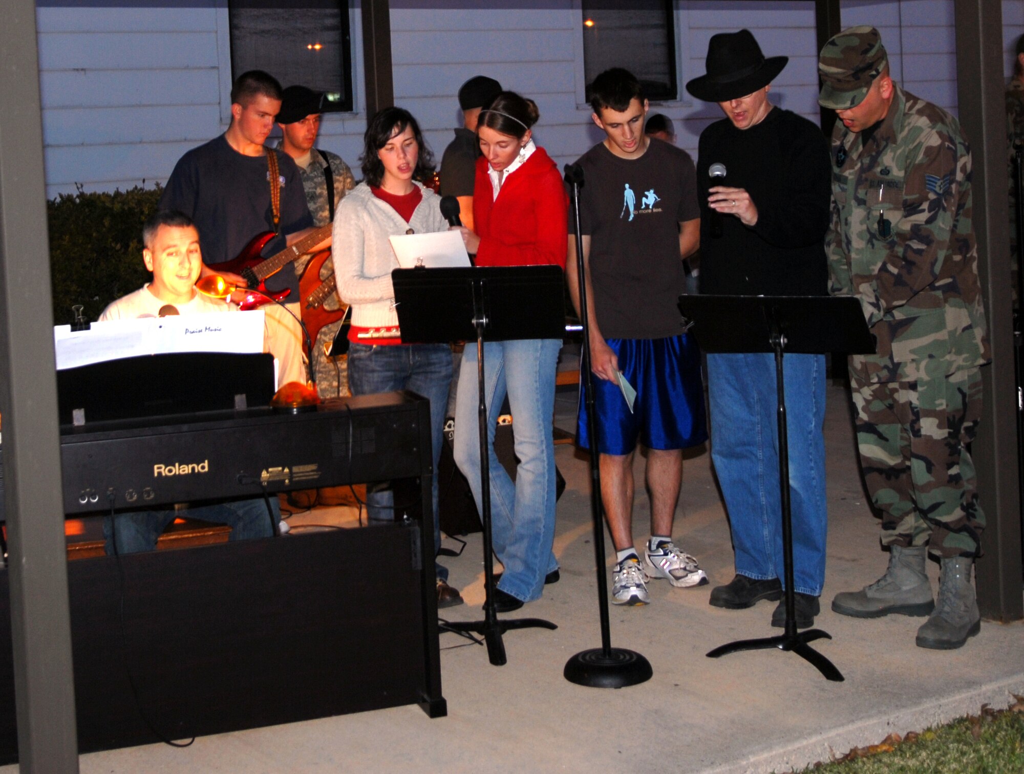 Tech. Sgt. Kelly Bales (on organ) leads a chapel choir in the singing of carols at the Christmas tree lighting ceremony Dec. 6. (U.S. Air Force photo by Staff Sgt. John Barton)