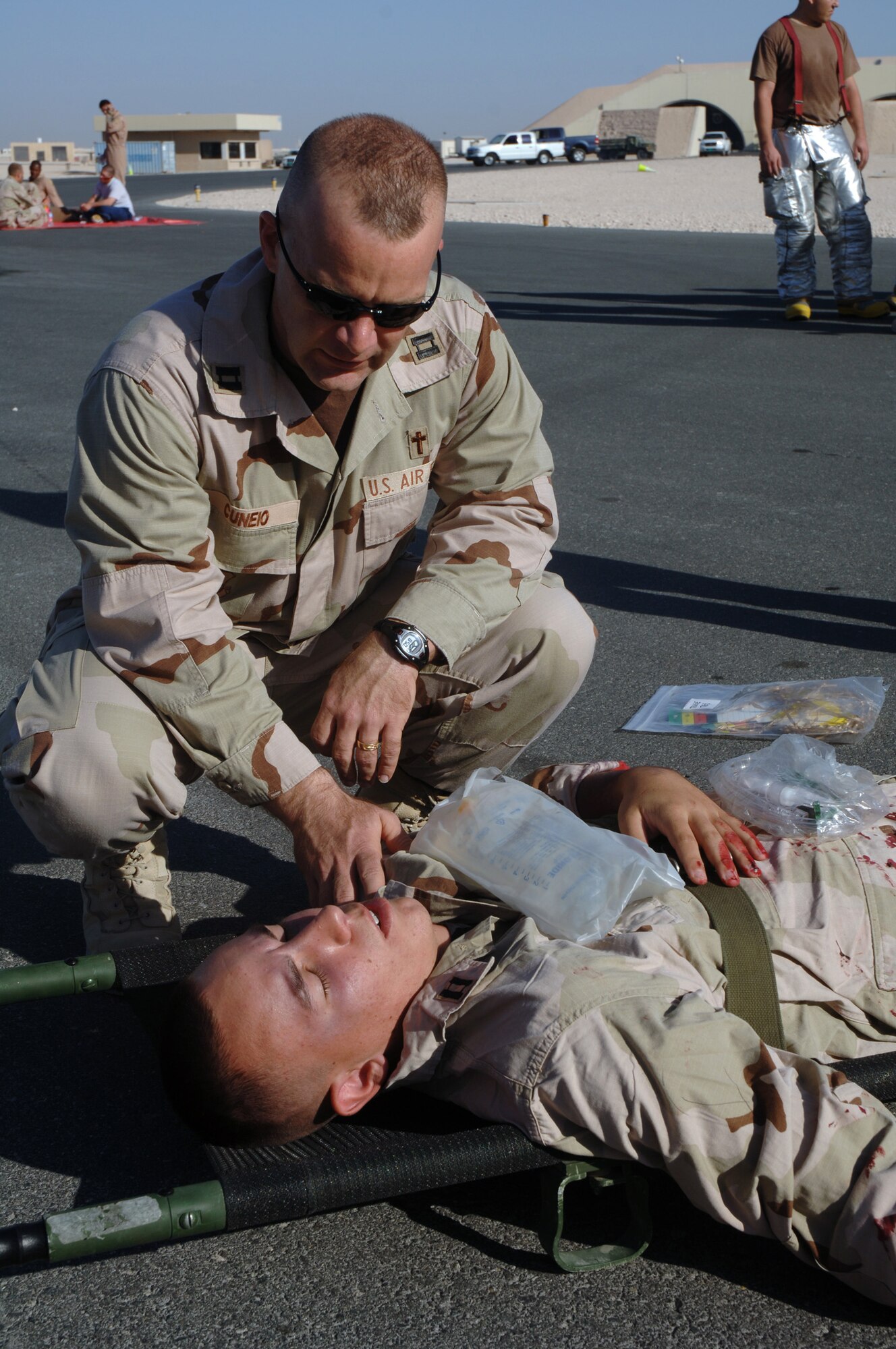 SOUTHWEST ASIA-  Chaplain (Capt.) Steven Cuneio, 379th Air Expeditionary Wing, comforts an Airman during a Major Accident Response Exercise Dec. 14 at a Southwest Asia air base. Chaplain Cuneio is deployed from Goodfellow AFB, Texas. (U.S. Air Force photo/Staff Sgt. Douglas Olsen)