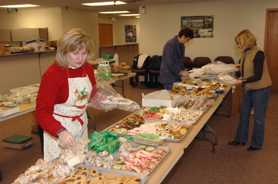 MINOT AIR FORCE BASE, N.D.-- Julie Tims, wife of Colonel Gregory Tims, 91st Space Wing vice commander, volunteers her time and efforts to help package cookies to be given to the Airmen living in the dorms. The cookie drive has become an Air Force tradition whereby the base and community have been giving of their time and efforts to show Airmen they appreciate all that they do. (U.S. Air Force photo by Airman First Class Cassandra Jones)