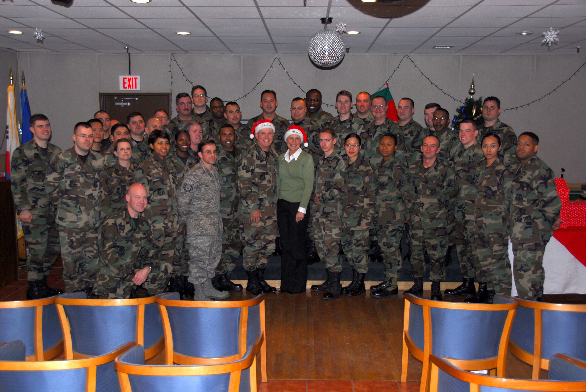 OSAN AIR BASE, Republic of Korea -- Lt. Gen. and Mrs. Stephen and Denise Wood pose with Airmen at Daegu Air Base after delivering cookies for Operation Cookie Crunch on Dec 14. (U.S. Air Force photo by Staff Sgt. Ronnie Hill)  