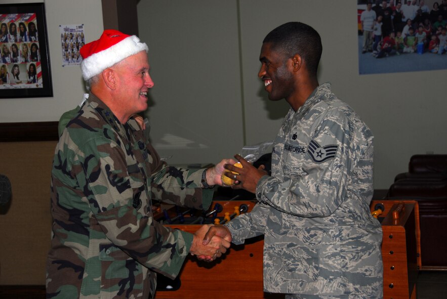 OSAN AIR BASE, Repbulic of Korea -- Lt. Gen. Stephen Wood, 7th Air Force commander,delivers cookies to Staff Sgt. Jayshawn Allen and other Airmen at Suwon Air Base in support of Opreation Cookie Crunch on Dec. 14 (U.S. Air Force photo by Staff Sgt. Ronnie Hill) 