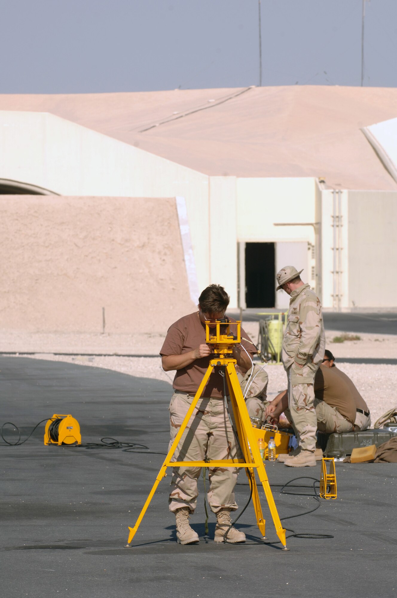 SOUTHWEST ASIA - U.S. Navy Chief Tara Novakowski, adjusts equipment she is using to provide compass calibration for the Navy P-3 Orions stationed at a Southwest Asia air base Dec. 14. Chief Novakowski is deployed to Ali AB, Iraq but was here with her team temporarily. The team's home station is Kaneoe Naval Base, Hawaii. Chief Novakowski is from Princeton, Minn. (U. S. Air Force photo/Staff Sgt. Douglas Olsen)