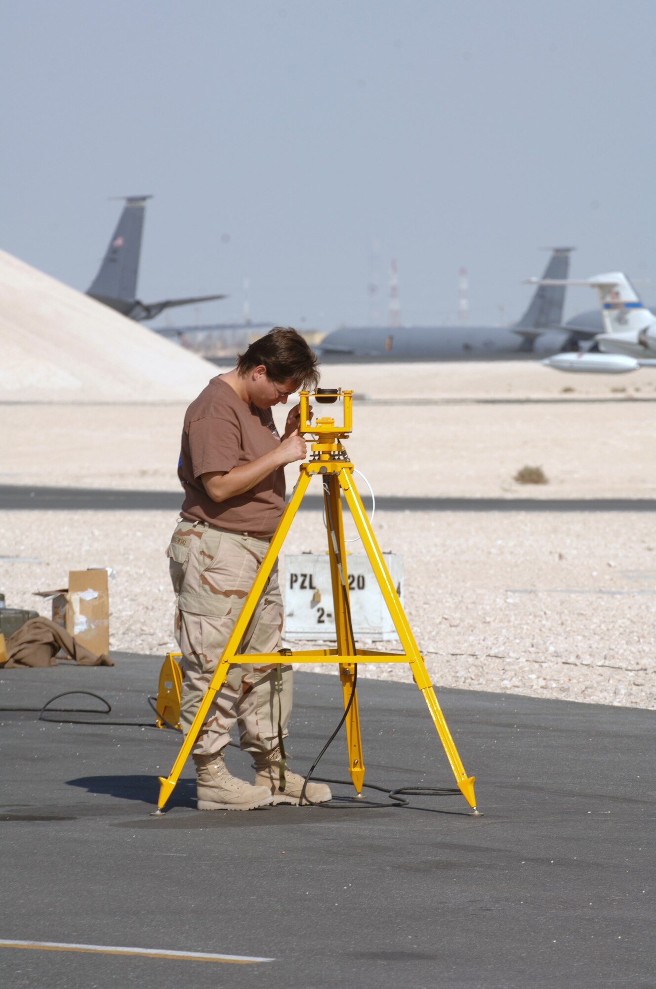 SOUTHWEST ASIA - U.S. Navy Chief Tara Novakowski, adjusts equipment she is using to provide compass calibration for the Navy P-3 Orions stationed at a Southwest Asia air base Dec. 14. Chief Novakowski is deployed to Ali AB, Iraq but was here with her team temporarily. The team's home station is Kaneoe Naval Base, Hawaii. Chief Novakowski is from Princeton, Minn. (U. S. Air Force photo/Staff Sgt. Douglas Olsen)
