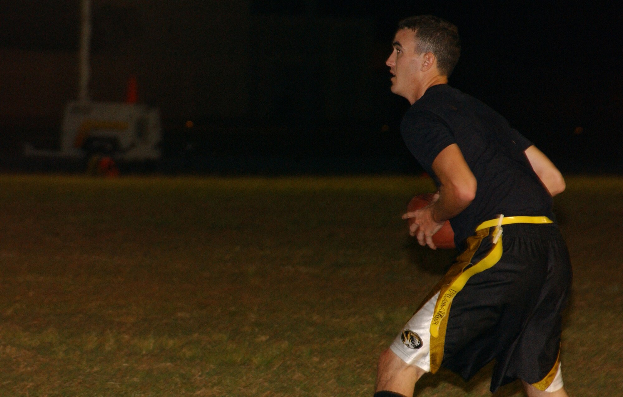 Tigers wide out, Senior Airman Todd “T.A.” Anderson, looks downfield for a receiver after Tigers quarterback Capt. Bill “Moose” Free zinged the ball to Airman Anderson in the flat behind the line of scrimmage. Airman Anderson is a great arrow in the Tigers’ quiver as he brings his height, speed and an impressive throwing arm to the EBS football team. (Air Force photo/Tech. Sgt. Steven Wilson)