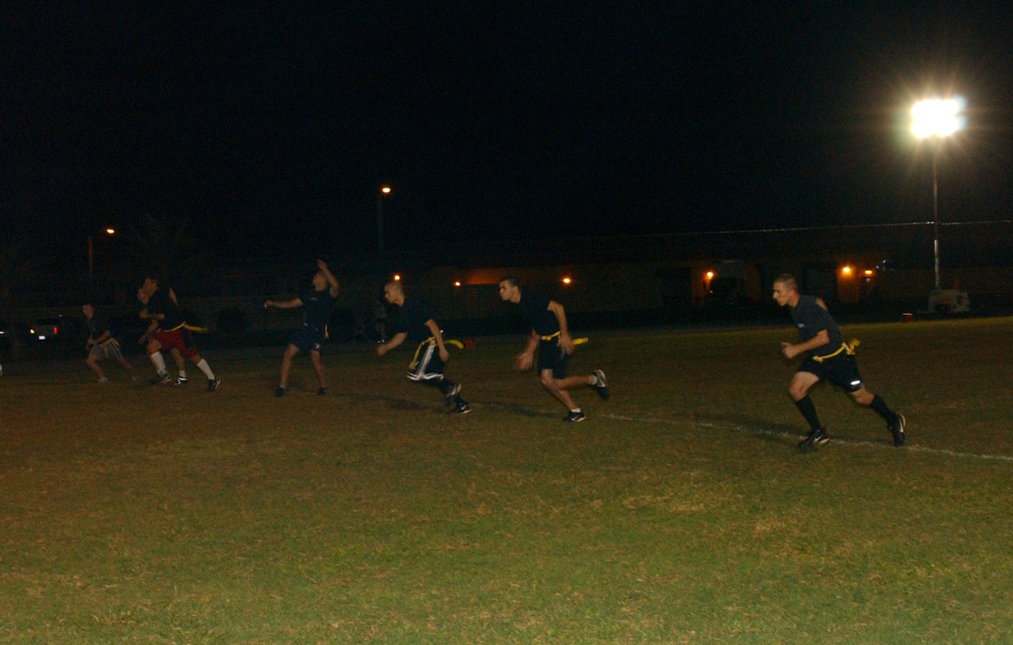 The 393rd Expeditionary Bomb Squadron, the Tigers, kick off to their opponents from the 366th Munitions Squadron in a flag football game here December 12. The Tigers special teams held their opponents to starting in their own territory following this kick. Both squadrons’ special teams were successful throughout the game in nullifying their opponents’ efforts to return the ball for a long gain after a kick off or punt. (Air Force photo/Tech. Sgt. Steven Wilson)