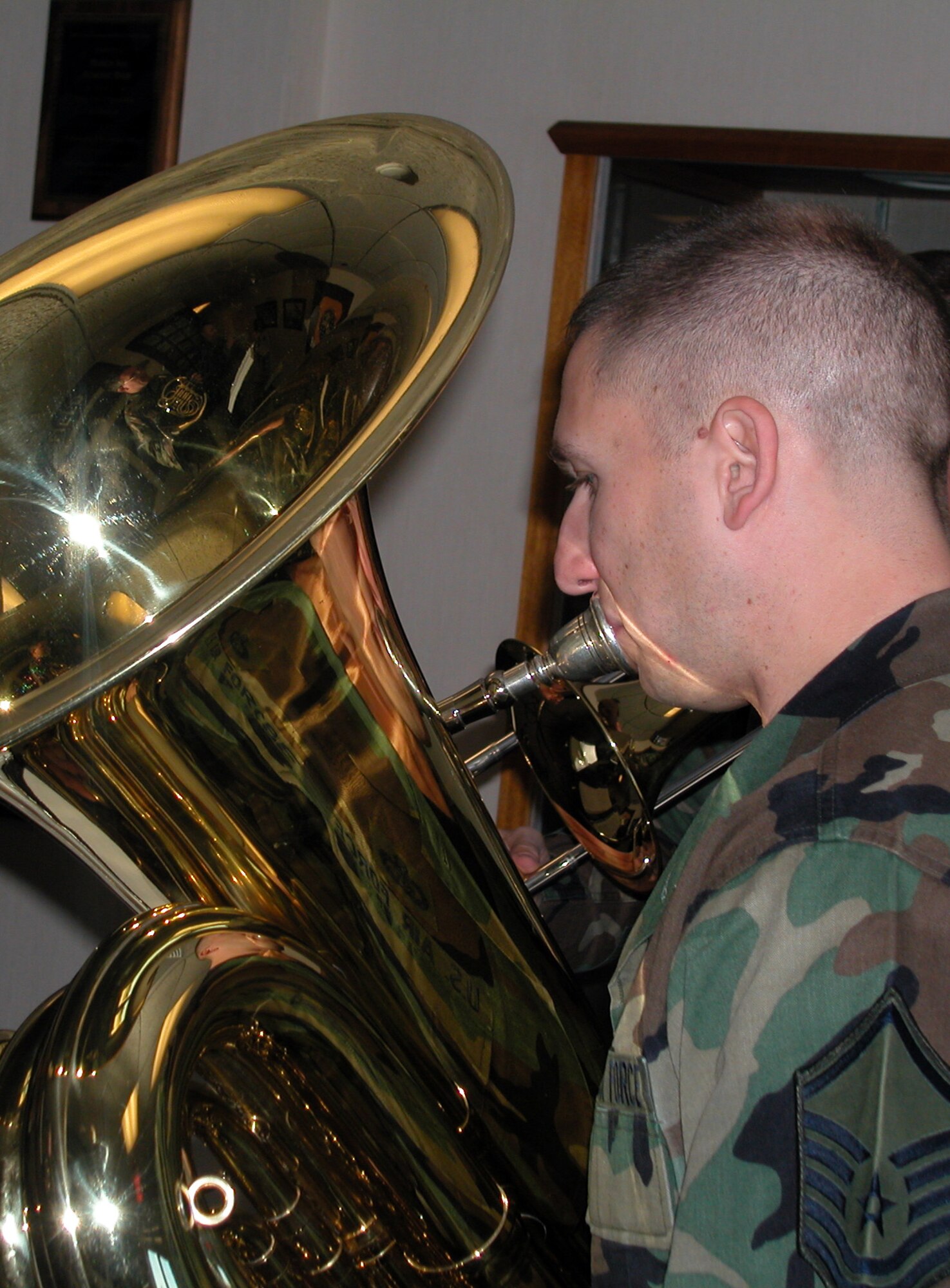 The U.S. Air Force Band of the Golden West from Travis Air Force Base, Calif., poses for a quick shot in the wing headquarters during their visit to March ARB. On Tuesday, they performed at various locations around base. Their last set of the afternoon was played at the Moreno Valley City Hall. The Holiday caroling group is comprised of Master Sgt. Michael Goetz, on tuba, Technical Sgts. James Masters and Tom
Hanrahan and Staff Sgts Scott Ruedger and Ed Schubert. (U.S. Air Force photo by Amy Abbott)