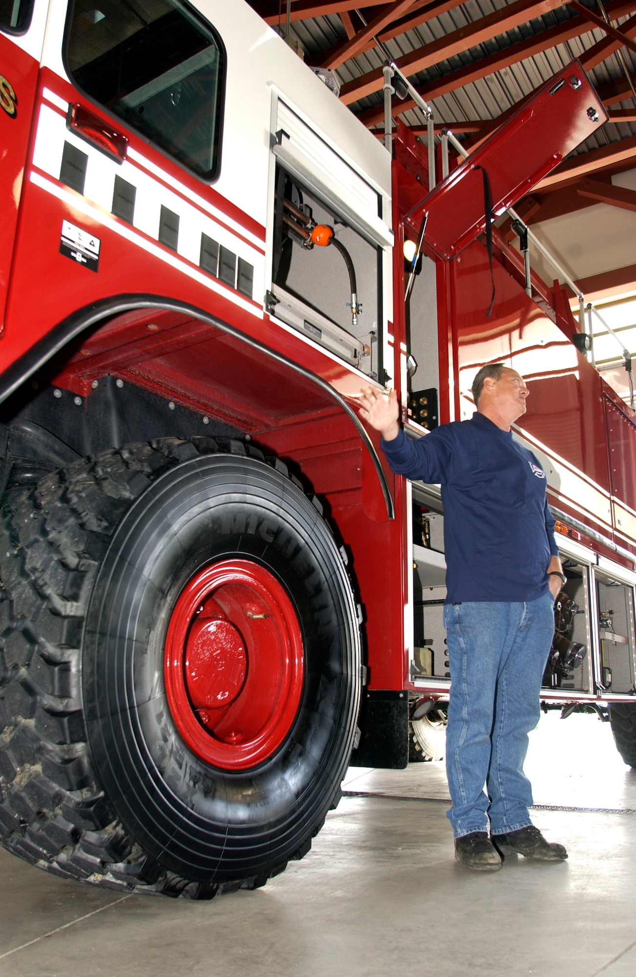 Mr. Jim Lindsay, right, the Oshkoshcertified factory representative fromToronto, Canada, reviews aspects of the new truck with the fire department team. (U.S. Air Force photo by Staff Sgt. Amy Abbott)