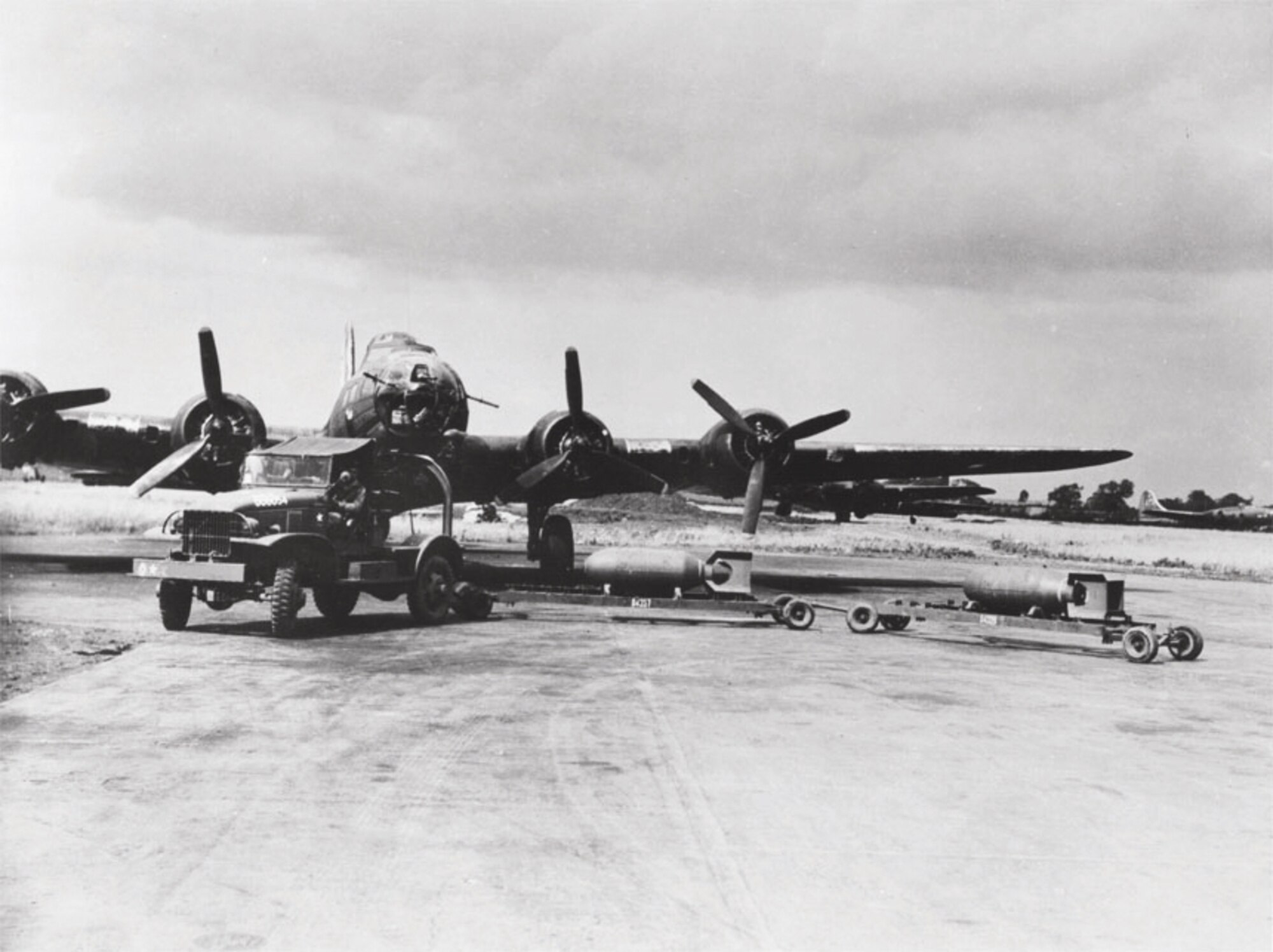 An ordnance crew loads bombs on an England-based B-17 Flying Fortress before it takes off on a mission over enemy territory.  (U.S. Air Force photo)