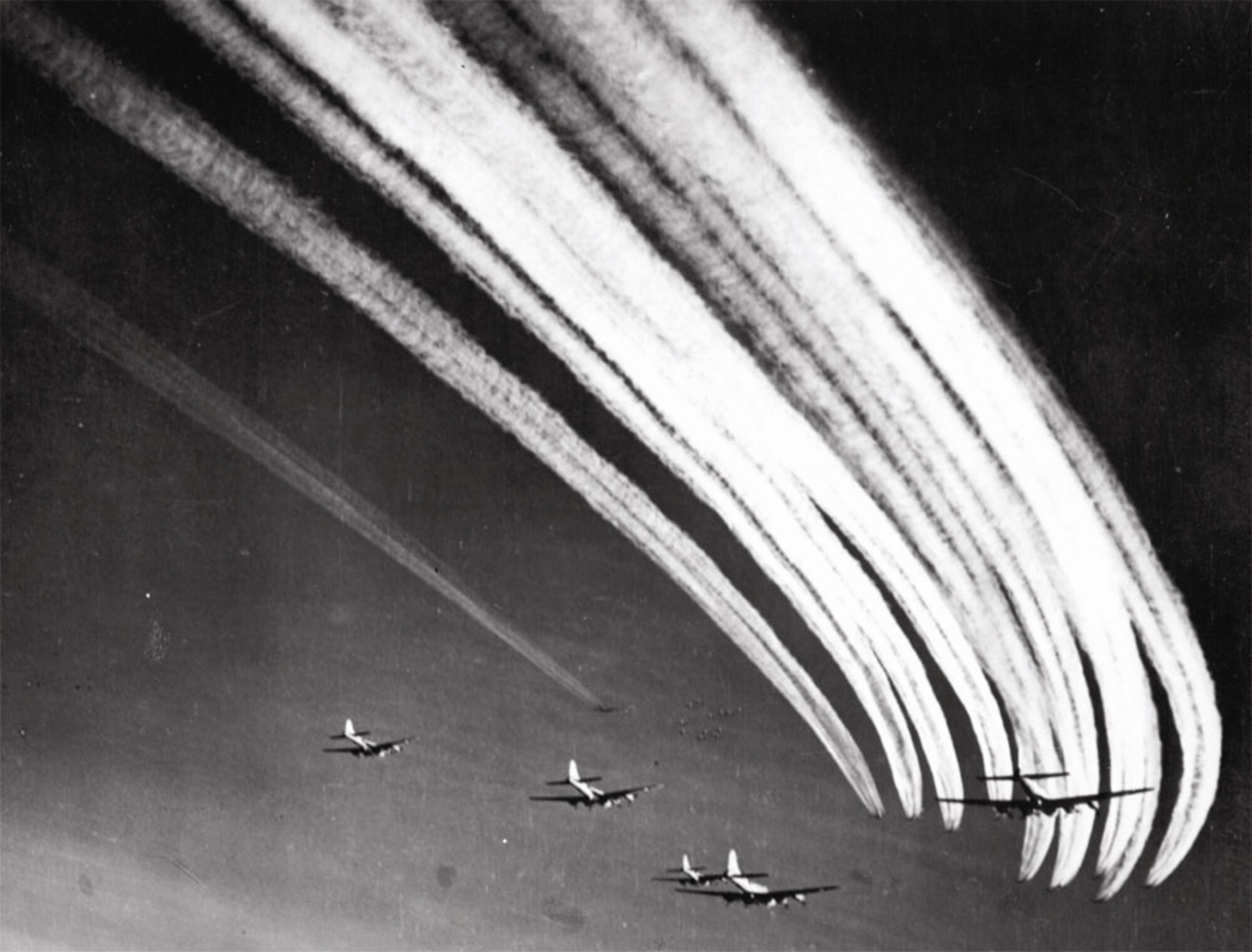 B-17 vapor trails fill the sky as Flying Fortresses join with each other for a mission. (U.S. Air Force photo)
