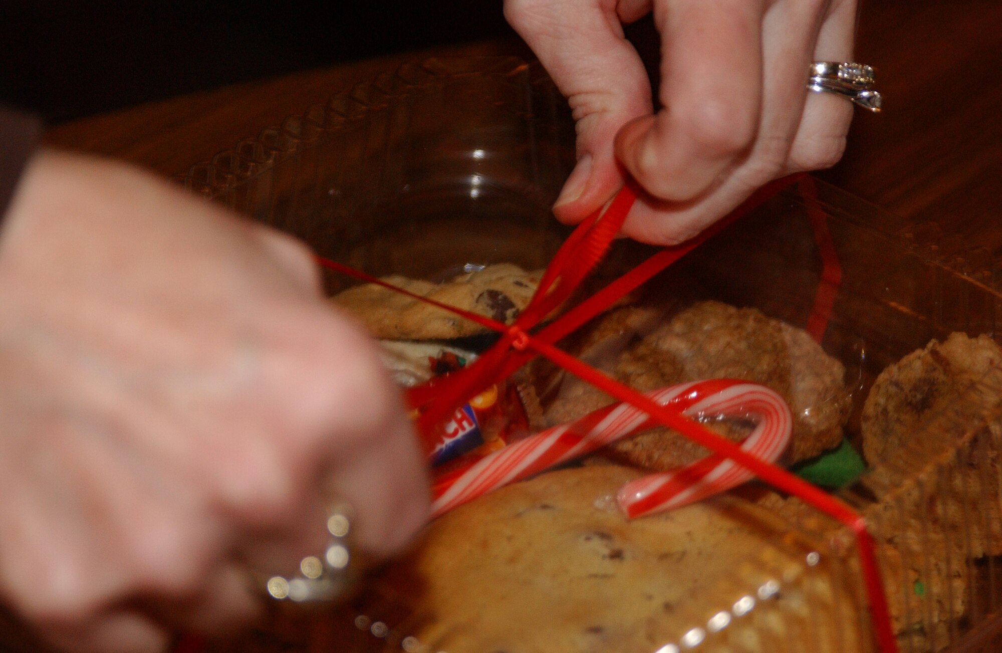 EIELSON AIR FORCE BASE, Alaska--A box of homemade cookies gets the finishing touches put on before being picked up for delivery during Operation Cookie Crunch Dec. 14, 2007, at the Yukon Club. The Eielson Officer's Spouses Club sponsors and organizes the yearly event. More than 550 homemade cookies are dropped off and packaged by volunteers and then delivered by squadron first sergeants to single Airmen living in the dormitories as a holiday gesture. (U.S. Air Force photo by Airman 1st Class Nora Anton)                       