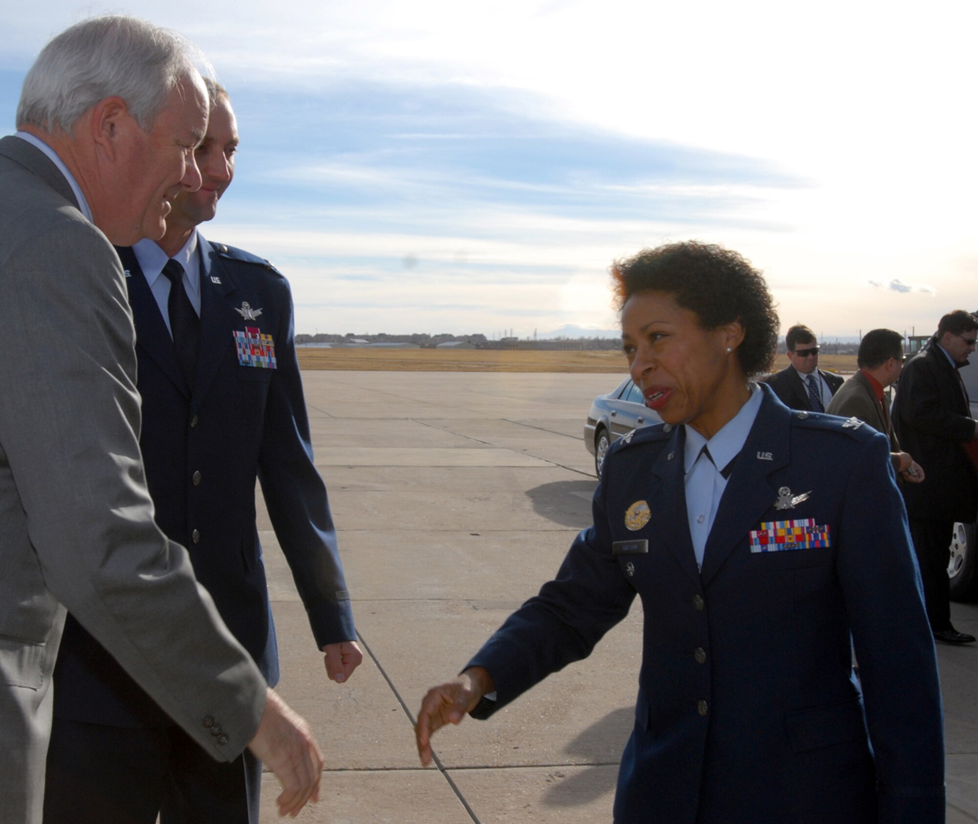 BUCKLEY AIR FORCE BASE, Colo. -- The honorable Michael Wynne, Secretary of the Air Force, is greeted by Col. Charlotte Wilson, 460th Space Wing vice commander, as Col. Wayne McGee, 460th SW commander looks on, after he disembarks his aircraft on the Buckley tarmac. Secretary Wynne visited Buckley and was given a briefing by the 460th Operations Group on his way to Denver, Dec. 5. (U.S. Air Force photo by Airman 1st Class Michelle Furtado)