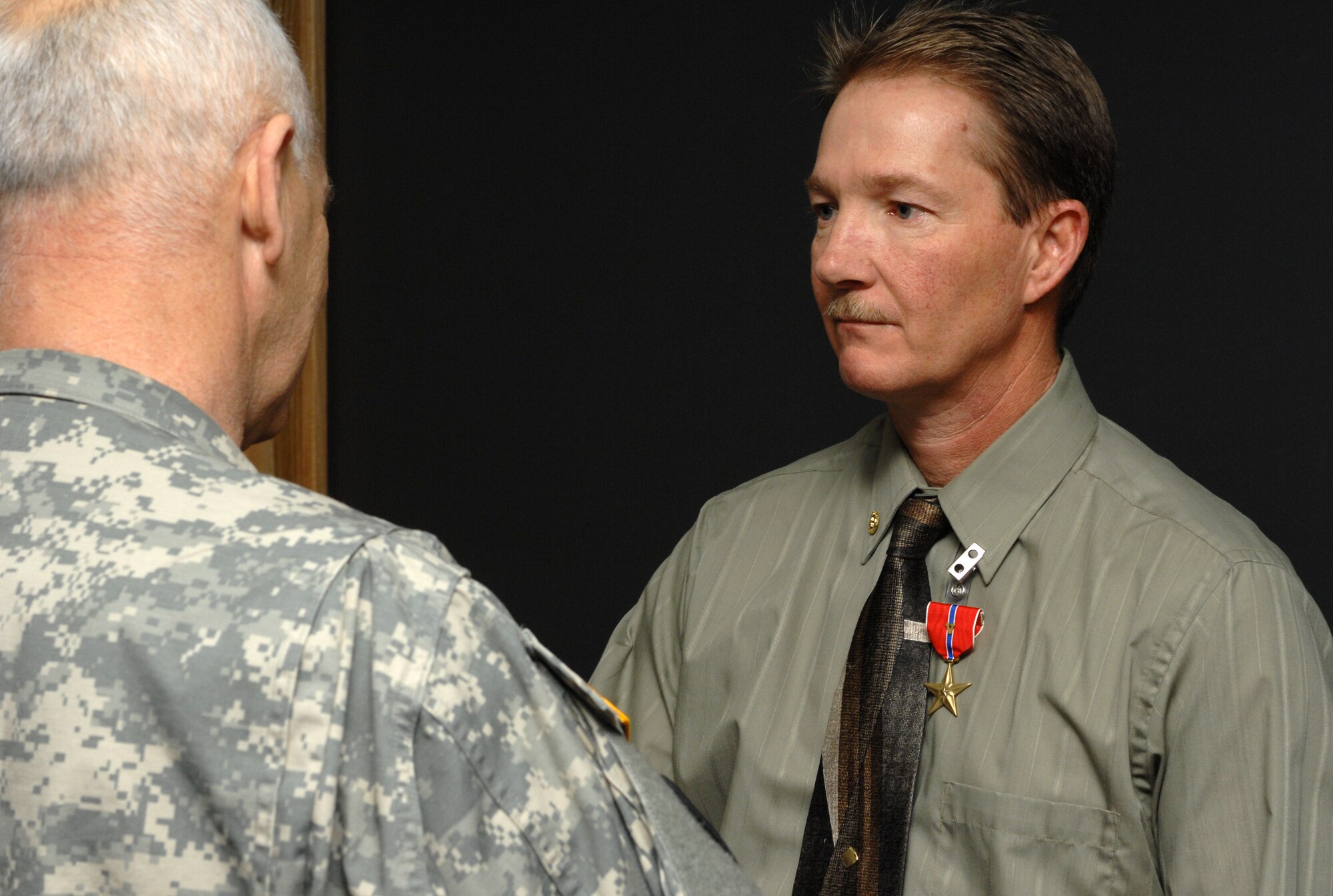 MOUNTAIN HOME AIR FORCE BASE, Idaho -- Left, Army Brig. Gen. Alan Gayhart, Idaho Air National Guard assistant adjutant, presented retired Master Sgt. Denny Elrod with a Bronze Star Medal with Valor for his son’s service. Army Specialist Steven R. Elrod was posthumously presented the award here Dec. 17 for actions in support of Operation Iraqi Freedom. Specialist Elrod received the award for exceptionally valorous achievement on May 13, but was killed in a vehicle accident in Baghdad Sept. 10. His father and his stepmother, Susan Elrod from the 366th Logistics Readiness Squadron, received one of the three medals for his actions while his grandparents Bob and Mary Morin received the other two. (U.S. Air Force photo/Airman 1st Class Ryan Crane)